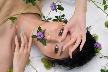 Overhead perspective of the woman arching her body amid dense foliage.