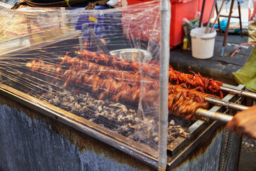 Close-up view of Rotisserie Quails on charcoal