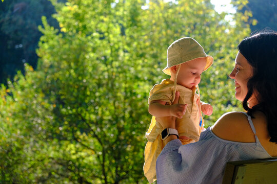 Mother and Baby Enjoying a Sunny Day in the Park Portrait - Powered by Adobe