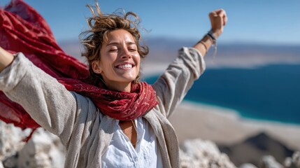A joyful woman raises her arms in celebration at a scenic outdoor location, embracing freedom and the beauty of nature with a vibrant atmosphere.