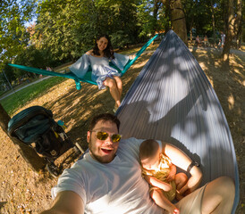 Family Relaxing in Park Hammocks Sunset time