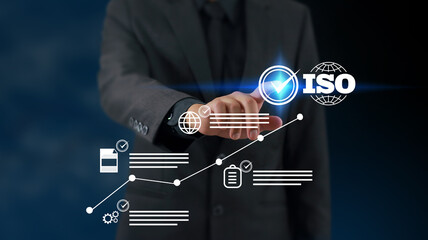 Businessman touching Quality assurance icon on digital screen with check mark icon for ISO certification and standardization. Quality assurance concept.