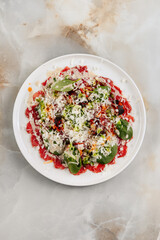 Loaded nachos, a popular Tex-Mex dish, served on a plate with melted cheese, jalapeños, fresh salsa, guacamole, and sour cream, ready to enjoy as a flavorful appetizer or snack.