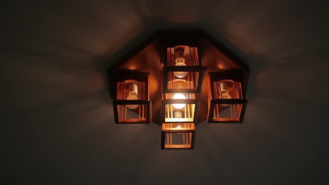 Broken flickering lamps flashes on the ceiling of a dark room