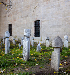 Ottoman cemetery under trees beside historic mosque Tarakli