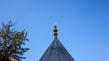 Golden finial above historic mosque roof in Tarakli Sakarya