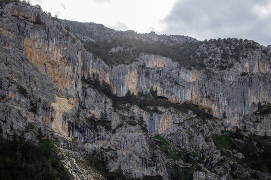 Vast rocky mountainside under soft diffused cloudy light