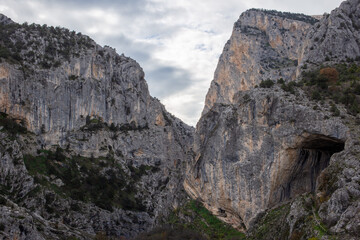 Wide canyon entrance framed by towering rocky cliffs