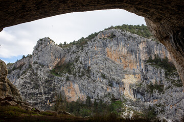 Canyon landscape framed beneath large rock overhang