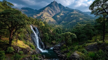 Serene waterfall cascading in lush mountains.