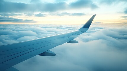 Obraz premium Airplane Wing Above Clouds at Sunset with Beautiful Sky Colors and Soft Sunlight Casting Warm Glow in the Background over Horizon