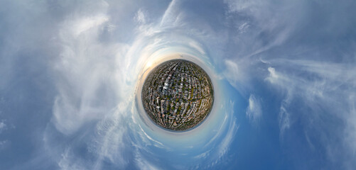  a landscape surrounded by swirling clouds and blue sky