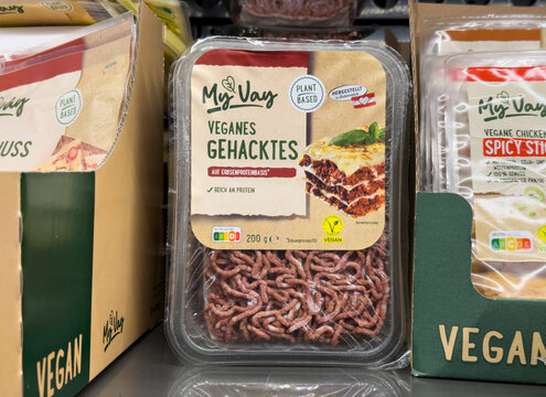 Vegan minced meat alternative made of pea protein in cooling shelf of German Aldi S&uuml;d supermarket, protein rich plant-based ground beef or ground pork, pre-packed meat product from plants