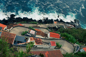 Coastal Village Nestled Above Crashing Waves