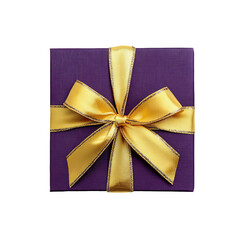 Dark purple gift box with golden ribbon from top view on a white background.