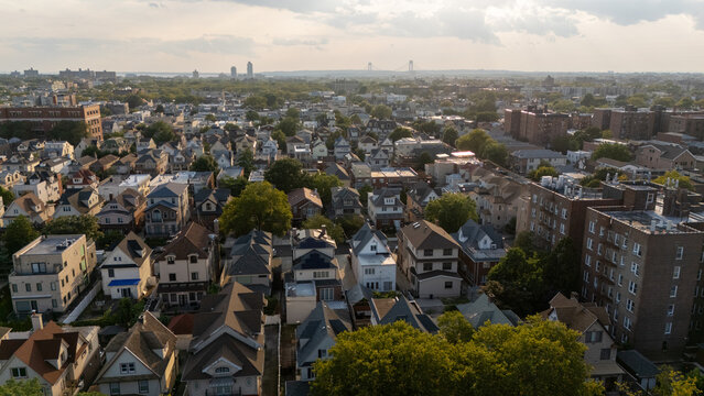 City skyline at dusk, lights twinkling, tall buildings against a colorful sky,