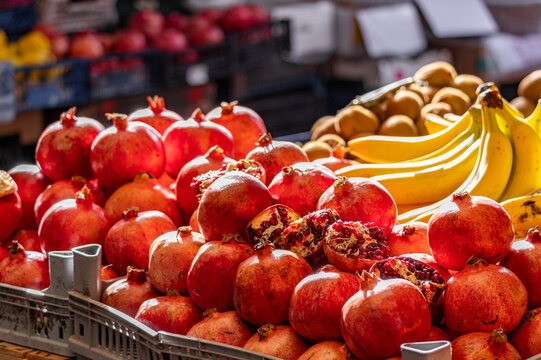 Red fresh pomegranate, Fresh red pomegranates at the local farmers' market, Pomegranate garnet fruit background. Fresh organic garnets. Farmers' market with fresh fruits and vegetables.