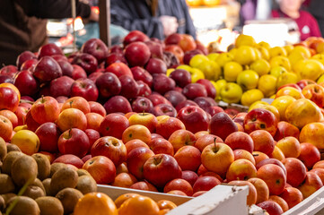 Red apples on a market stall. Yummy pile of apples in a market stall. Fresh red apples piled together in a market display organic healthy fruit background.