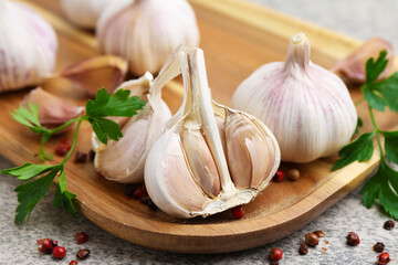 Garlic, peppercorns and parsley on light table, closeup