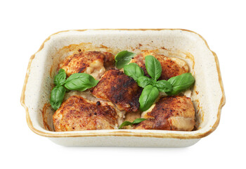 Tasty cooked chicken thighs with basil in baking dish isolated on white