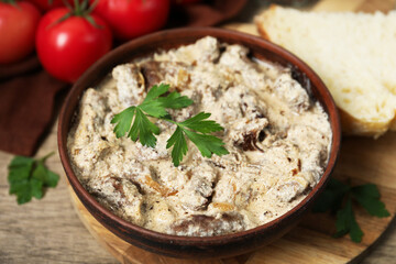 Tasty beef Stroganoff with parsley served on wooden table, closeup