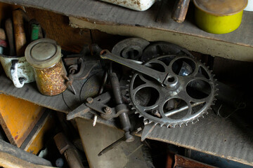 Vintage Bicycle Crankset and Various Tools on a Dusty Shelf