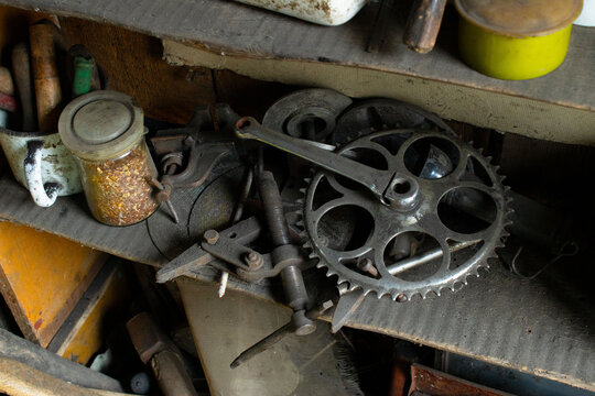 Vintage Bicycle Crankset and Various Tools on a Dusty Shelf