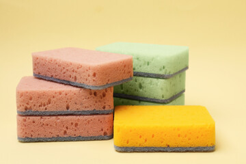 Different kitchen sponges on beige background, closeup
