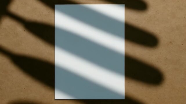 Close-up of a blank white paper with changing shadows cast by bottles shot in natural light on a brown textured surface showcasing light and shadow interplay throughout the visual narrative