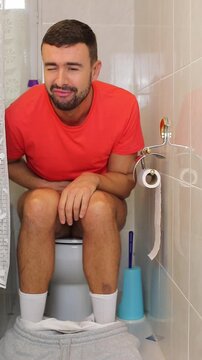 Comedic man feeling a relief in the toilet 