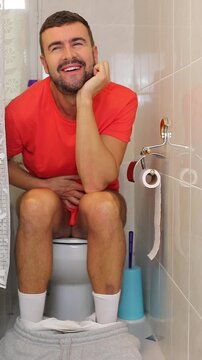 Candid Humorous Video of a Caucasian Man in the Toilet Making a Comically Relieved and Ecstatic Face 