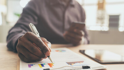 Businessman working on graph on table