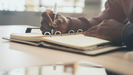 A man writing in a notebook