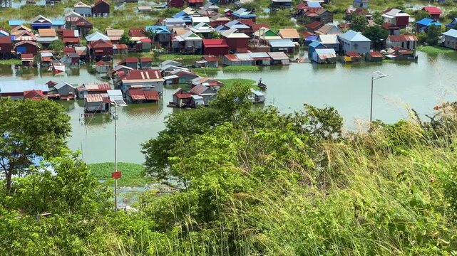 Viewpoint of a flooded fishing village near the Krahom Temple, Cambodia. From the mountain Krahom (Pnom Krom) overlooking the lake Tonlesap. Houses are built on high stilts. Rainy season. 4К