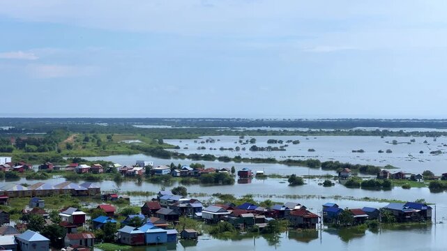 Viewpoint of a flooded fishing village near the Krahom Temple, Cambodia. From the mountain Krahom (Pnom Krom) overlooking the lake Tonlesap. Houses are built on high stilts. Rainy season. 4К