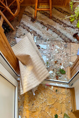 KYIV, UKRAINE - JUNE 6, 2025: Damage to the balcony of a residential building after a drone strike, showing broken windows and debris on the wall.