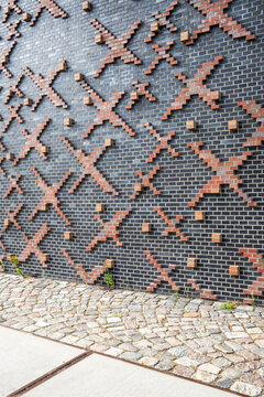 Contemporary architecture showing facade relief and pattern grids where geometry interacts with background light and contrast across a modern structure shaped by abstract design and urban texture