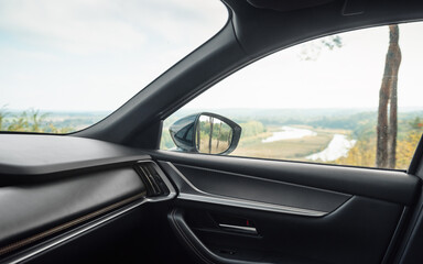 Car front side window. Looking at the river valley in the background through passenger door.