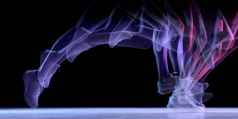 Fototapeta premium Dynamic motion-trail silhouette of running legs on dark background. Concept of biomechanics study, speed analysis, training visuals, injury-prevention tutorials, and performance-tracking content.