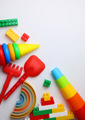 A vibrant display of childrens toys on a bright yellow backdrop, perfect for playful themes and joyful imagination. Vertical photo format
