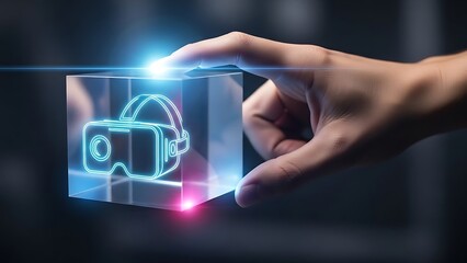 A person's hand touching a glowing holographic cube displaying a virtual reality headset icon, symbolizing futuristic technology and the metaverse.
