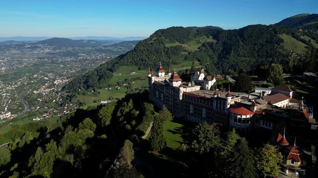 Aerial drone footage of SHMS Swiss Hotel Management School campus in Montreux, Switzerland, showcasing modern architecture, scenic Lake Geneva, and surrounding mountains