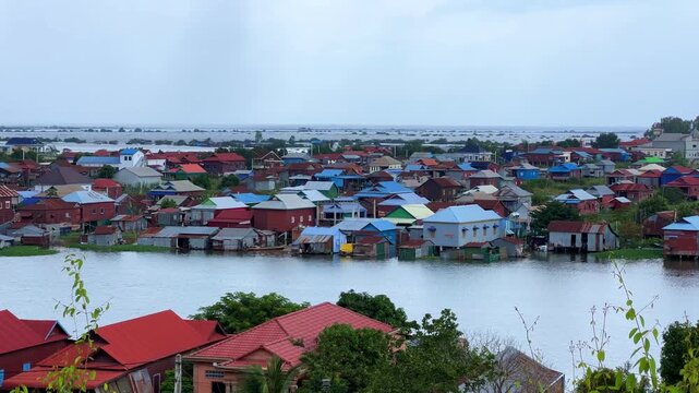 Viewpoint of a flooded fishing village near the Krahom Temple, Cambodia. From the mountain Krahom (Pnom Krom) overlooking the lake Tonlesap. Houses are built on high stilts. Rainy season. 4К