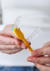 Aligners for straightening teeth on a light background. Vertical photo format