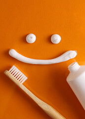 Toothpaste and toothbrush on a colored background. Dental care, oral health. Vertical photo format