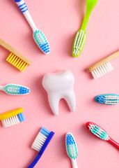 Different toothbrushes on a colored background. Dental care, oral health. Vertical photo format