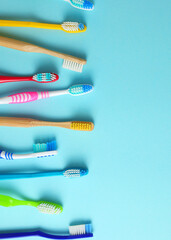 Different toothbrushes on a colored background. Dental care, oral health. Vertical photo format
