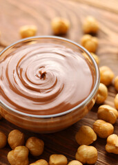 chocolate paste with a bowl on a table.  Vertical photo format