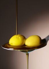 Vertical photo format. A premium olive oil with olives and fresh leaves, top view 