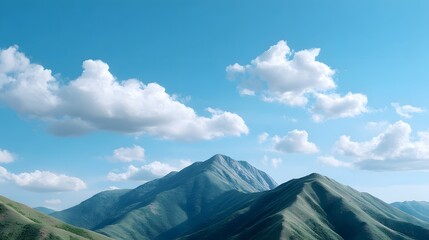 Expansive view of rolling green mountains and rugged peaks reaching towards a vibrant blue sky filled with fluffy white clouds